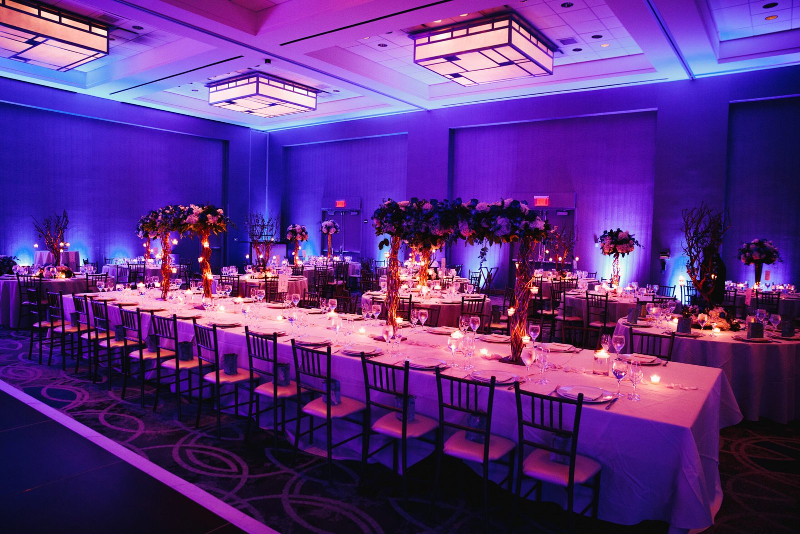 Decorated banquet hall with flowers, rectangle table, chiavari c